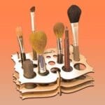 A wooden holder with many different brushes in it.